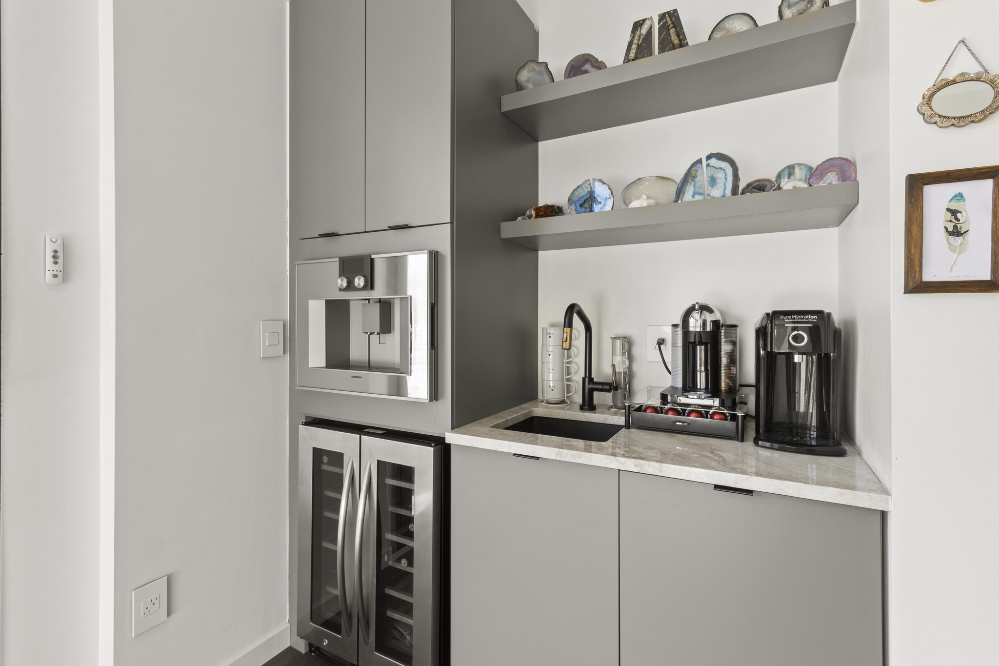 Bespoke Colorado custom home kitchenette with stainless steel wine cooler and agate-decorated shelves custom design photography in castle pines colorado
