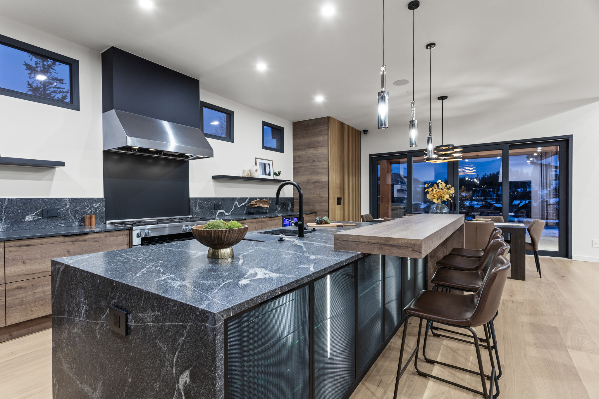 Custom Builder Photography for interior design of Elegant modern kitchen featuring bespoke island design, marble surfaces, and stylish pendant lighting for a luxurious feel